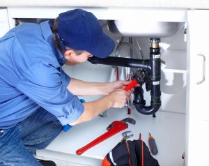 A man repairing a sink