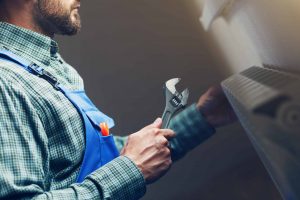 A man holding a crescent wrench