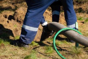 A worker installs a trenchless sewer line