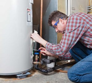 A man installing a water heater