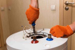 A man working on a hot water heater