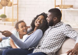 A family watching television on a sofa