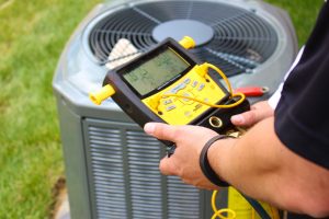 HVAC technician checking outdoor AC unit.