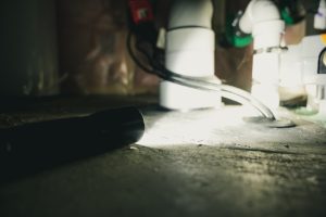 white sump pump system in a basement